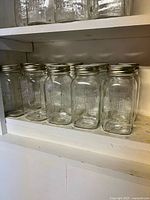 Shelf view showing two rows of Canadian Mason jars