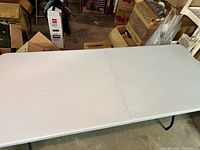 Top view of unfolded white folding table