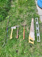 All seven tools laid out on grass