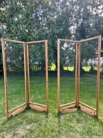 Both folding garden screens standing open on lawn