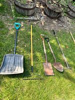 All five tools laid out on grass
