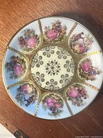 Front view of decorative plate showing pattern and gold detailing