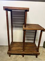 Front view showing full structure of wood slatted plant stand