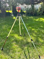 Full view of aluminum tripod sprinkler set up on lawn