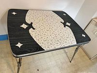 full view of table showing top surface design and legs