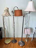 Four lamps grouped: three floor, one table