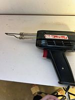 Left side view of Weller 8200 soldering gun showing label and tip