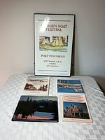 Group shot showing framed poster with all four books