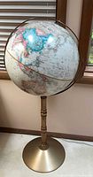 Full view of globe on stand