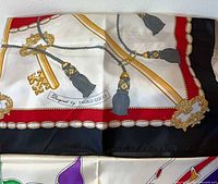 Close-up of Paolo Gucci key-and-tassel silk scarf