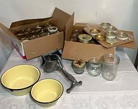 Full lot showing boxes of jars, aluminum ricer, enamel bowls, loose jars and lids