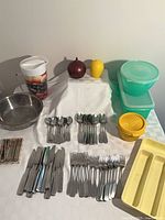 Full layout showing flatware, colander, tumbler, Tupperware, cutlery tray