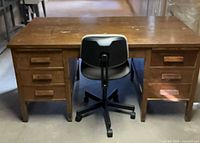 Front view of oak executive desk with chair