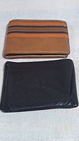 Brown striped wallet and black wallet front view