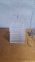 Stack of clear square acrylic plates forming lamp body