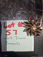 Full view of brooch beside lot note