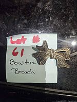 Bow brooch on note identifying lot