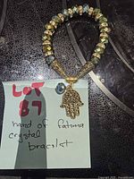 Full view of bracelet arranged in circle, showing beads, spacers, and Hamsa charm