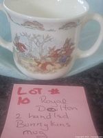 Front view of two-handled Bunnykins mug with note