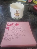 Egg cup front showing Bunnykins rabbit reading a book