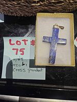 pendant in box next to lot note