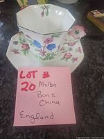 Teacup and saucer set with note showing brand and material