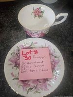 Teacup and saucer showing floral design and gold trim