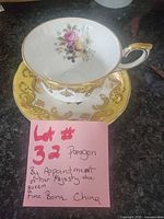 Teacup on saucer showing interior bouquet and gold rim
