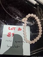 Full bracelet on dark surface with note