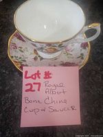 Royal Albert bone china teacup on matching saucer with floral pattern and gold trim