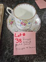 Teacup and saucer displaying pattern and gilt trim