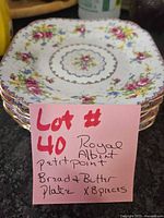 stack of eight Royal Albert Petit Point plates with handwritten lot note