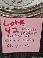 Stacked view of all eight Petit Point bowls showing pattern and gold rims