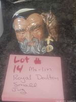 Front view of Merlin character jug with note indicating lot