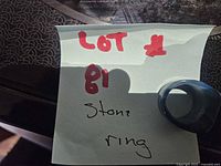 Ring placed on note showing lot number, view of overall piece