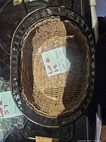 Top view showing oval wicker interior and metal rim