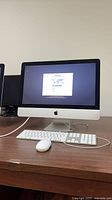 Front view of iMac powered on showing display