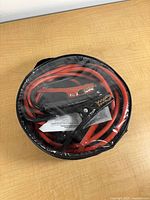 Cables coiled inside storage bag under clear plastic cover