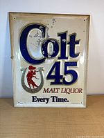 Front view of embossed Colt 45 advertising sign