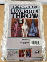 Front of packaged throw with retail insert showing product details