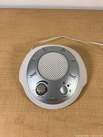 Top view of Homedics sound machine showing speaker, buttons, volume knob and indicator LEDs