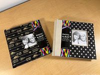 Both hardcover photo albums front covers visible