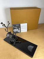 Wine rest on desk with box and literature visible