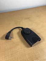 Full view of timer showing body, short cord with grounded plug, vented front