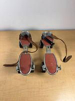 Top view of both skates showing red footplates and straps
