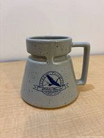 Front view of speckled Eddie Bauer mug showing logo and handle