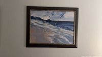 Overall view of framed coastal seascape print hanging on wall