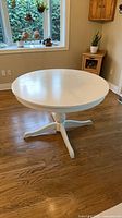 Round white pedestal dining table