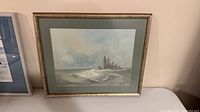Front view of framed seascape painting with mat and frame