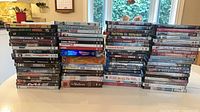 Four stacks of roughly 80 DVD movie cases showing spine titles and box sets